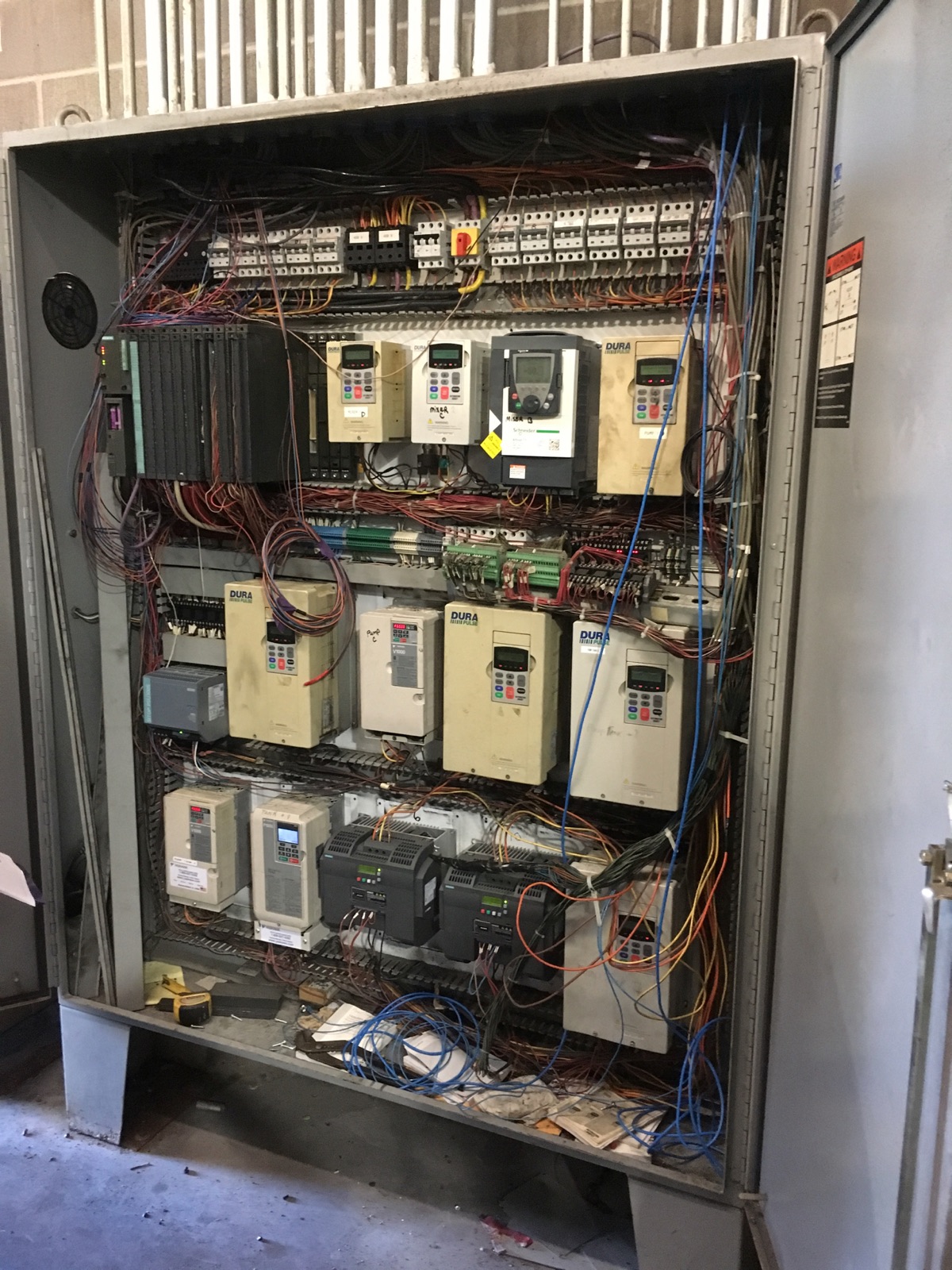 Drive panel before rebuild with mixed-brand drives and tangled wiring