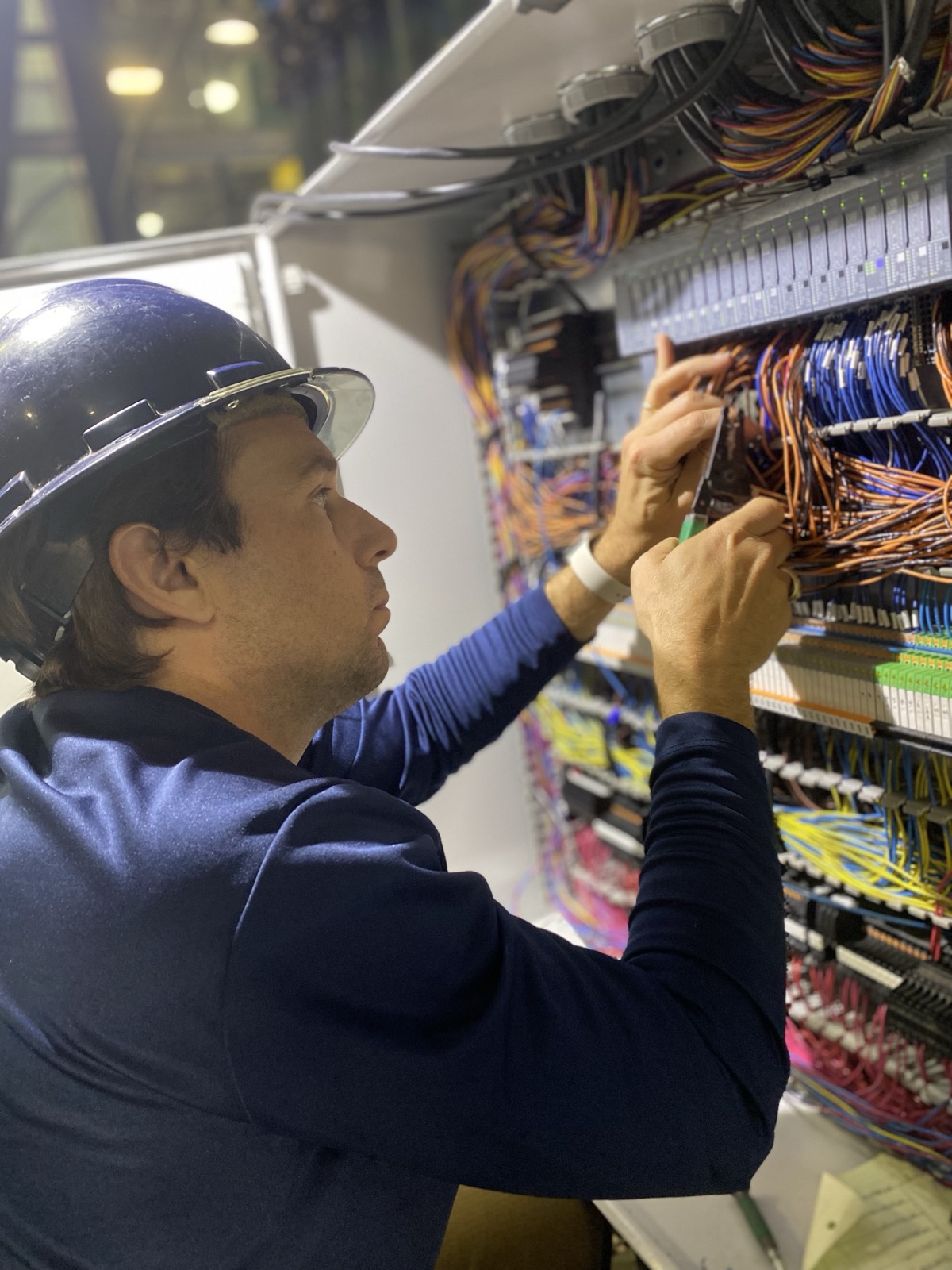 Engineer terminating field wiring in a control panel