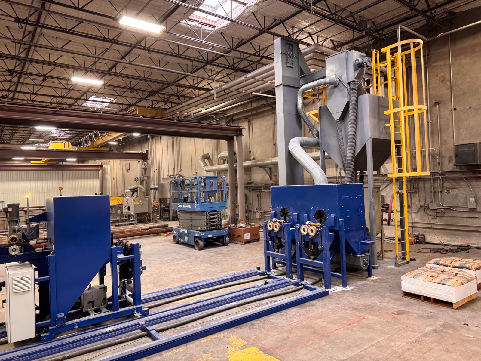 Enclosed surface preparation line with bucket elevator and cyclone reclaim