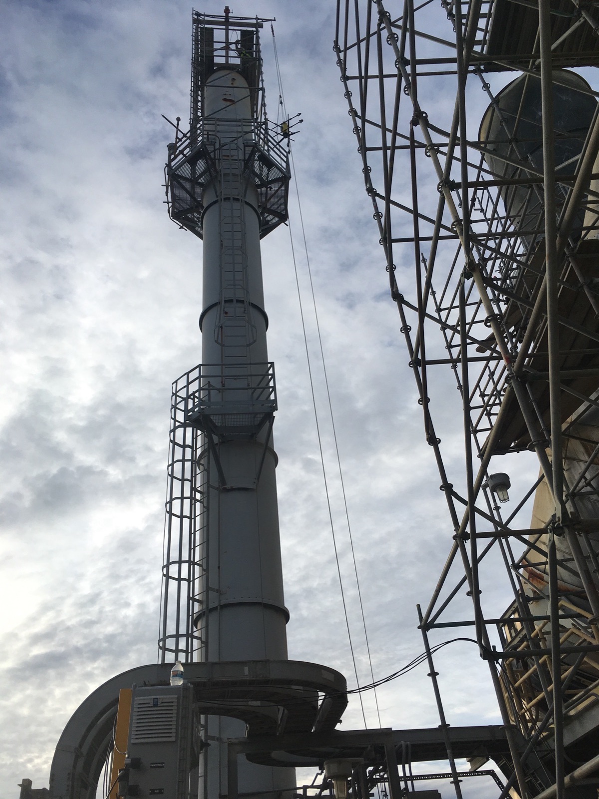 Tall industrial stack with scaffolding alongside
